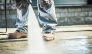 cleaning a patio with a pressure washer